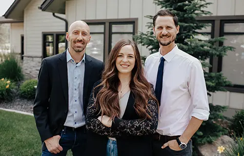 Doctors Coulter, Wheeler and Gilbert smiling together at Coulter Family Dentistry 