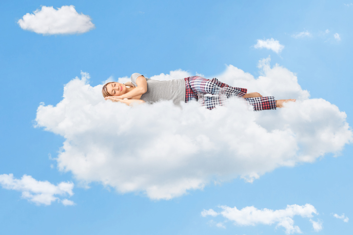 A woman having a great night's sleep symbolized by her sleeping on a cloud after receiving Sleep Apnea Treatment from Coulter Family Dentistry in Spokane Valley, WA