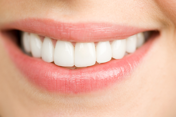 A patient with perfect teeth smiling after receiving a Fluoride Treatment from Coulter Family Dentistry in Spokane Valley, WA