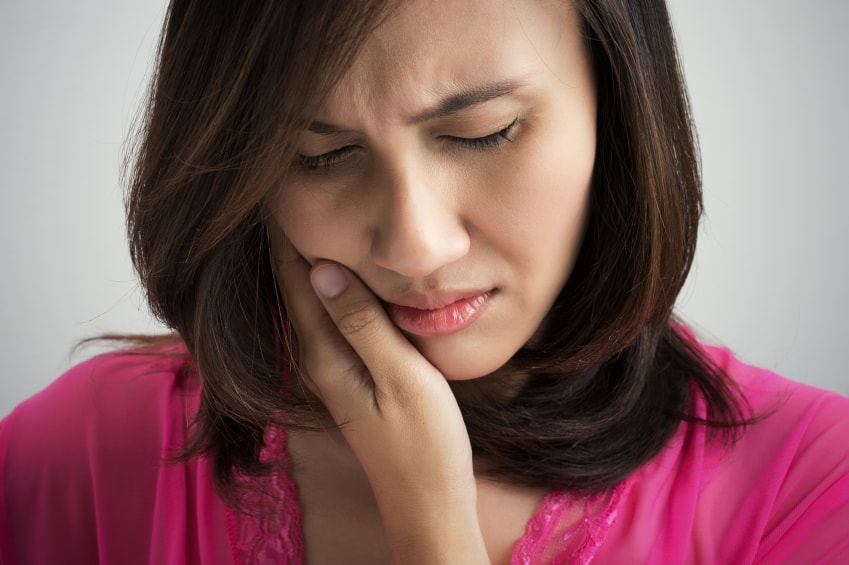 A woman experiencing a Dental Emergency in Spokane Valley, WA