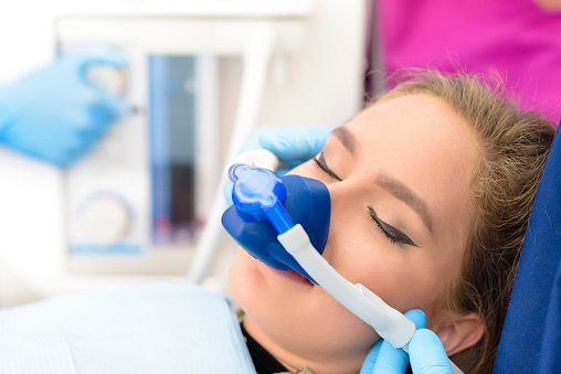 Woman experiencing nitrous oxide sedation.